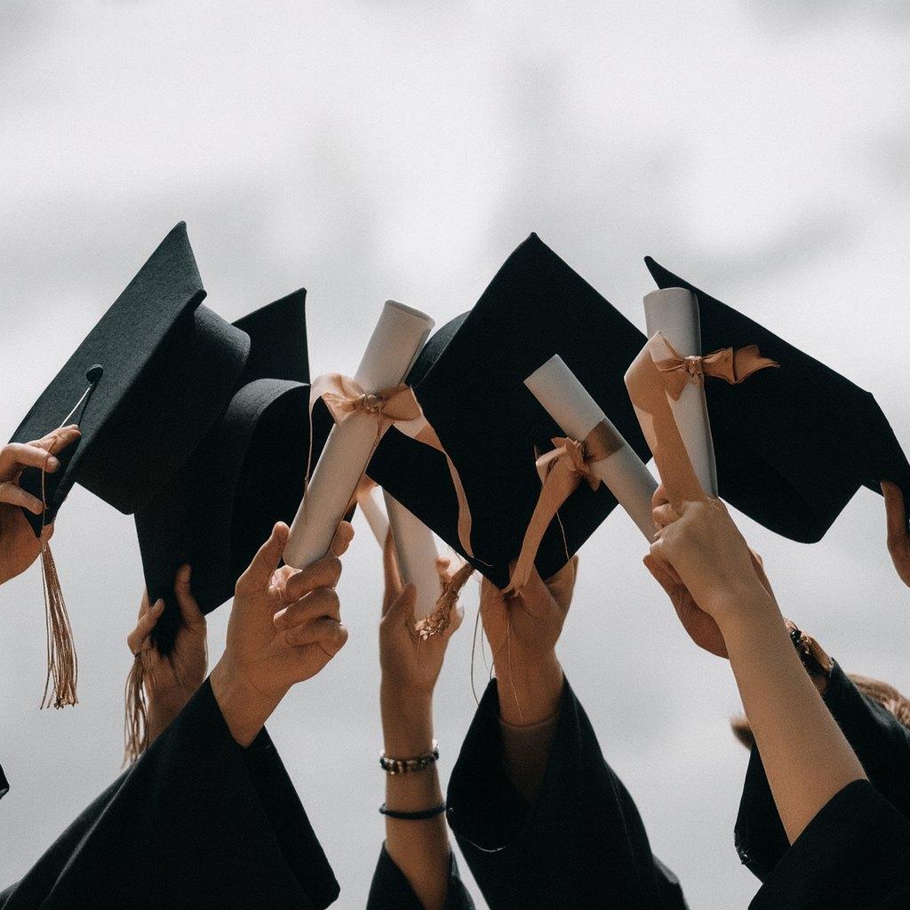 Graduates throwing their caps