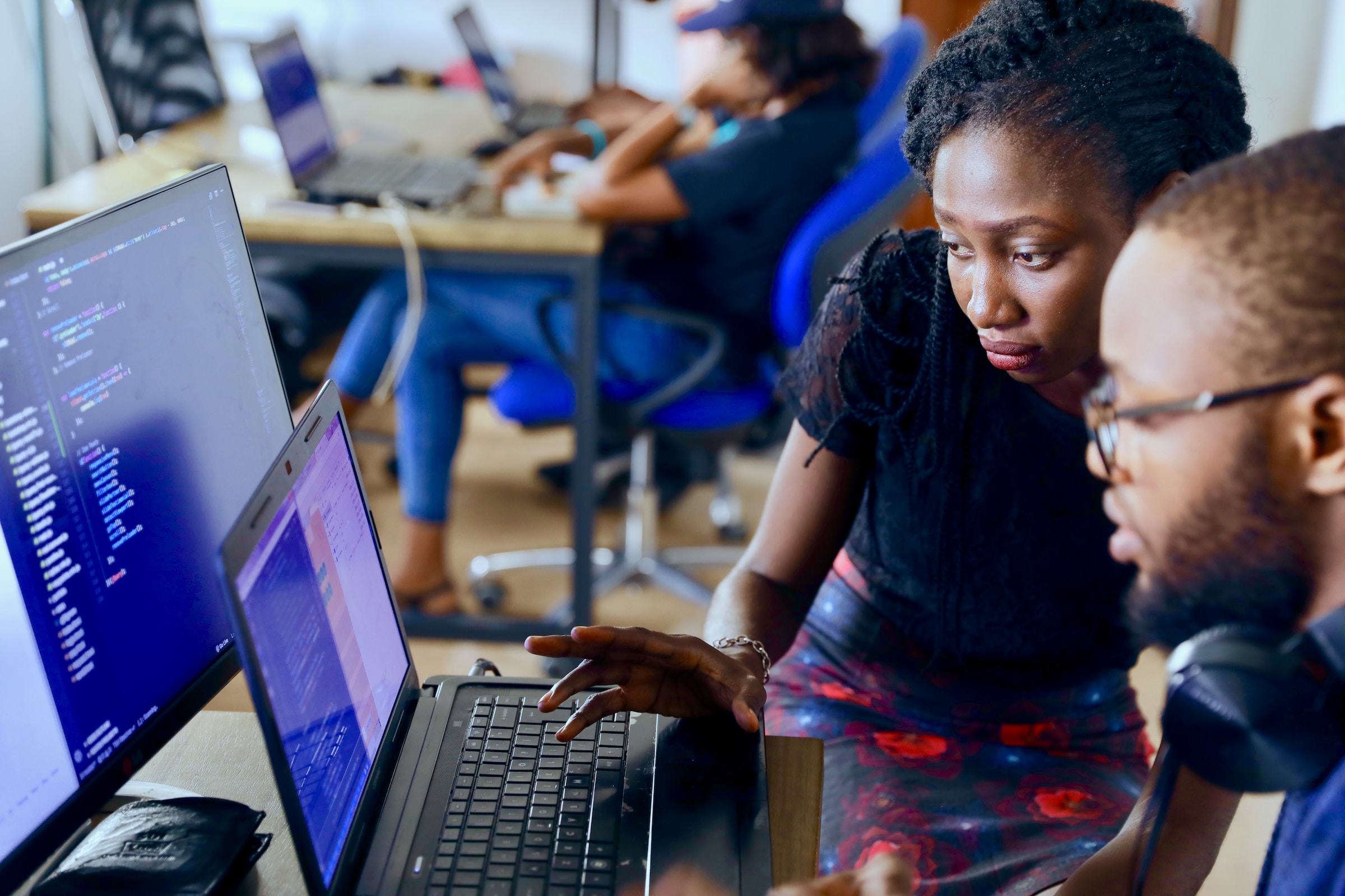 A Zaio mentor guiding a learner through code